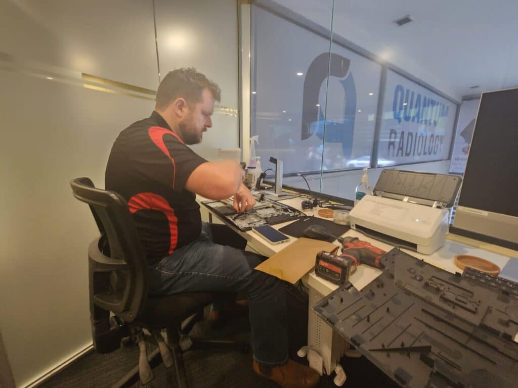 Technician working on HP All in One during memory upgrade